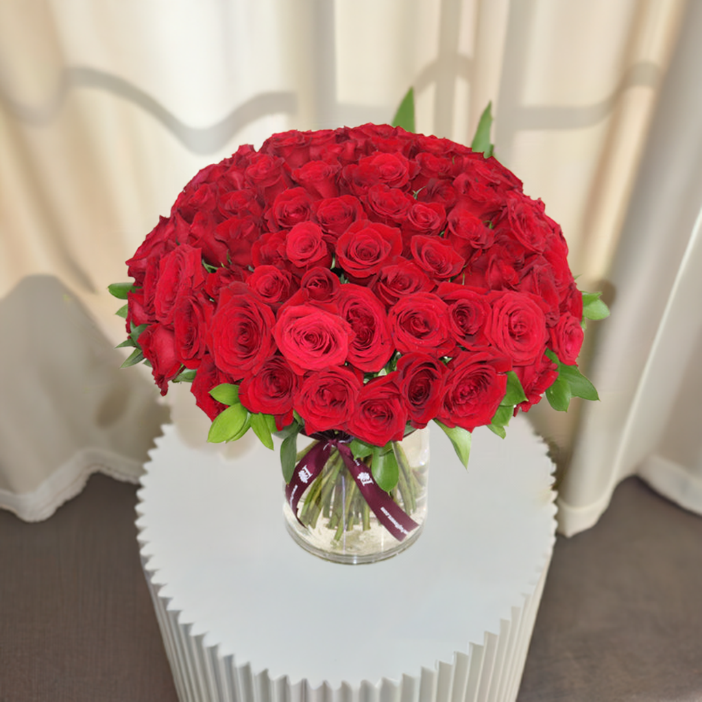 Elegant bouquet of 100 Red Roses Clear Vase beautifully arranged for special occasions