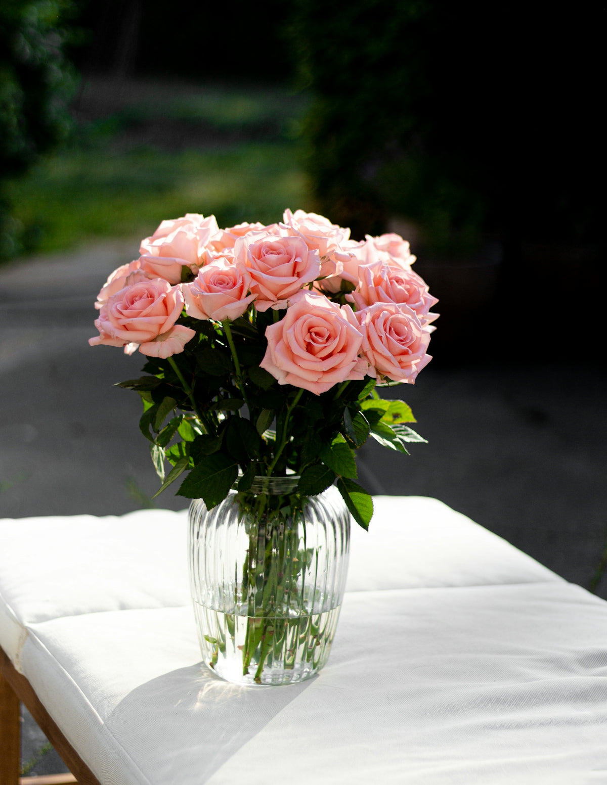 a vase filled with pink roses sitting on top of a table