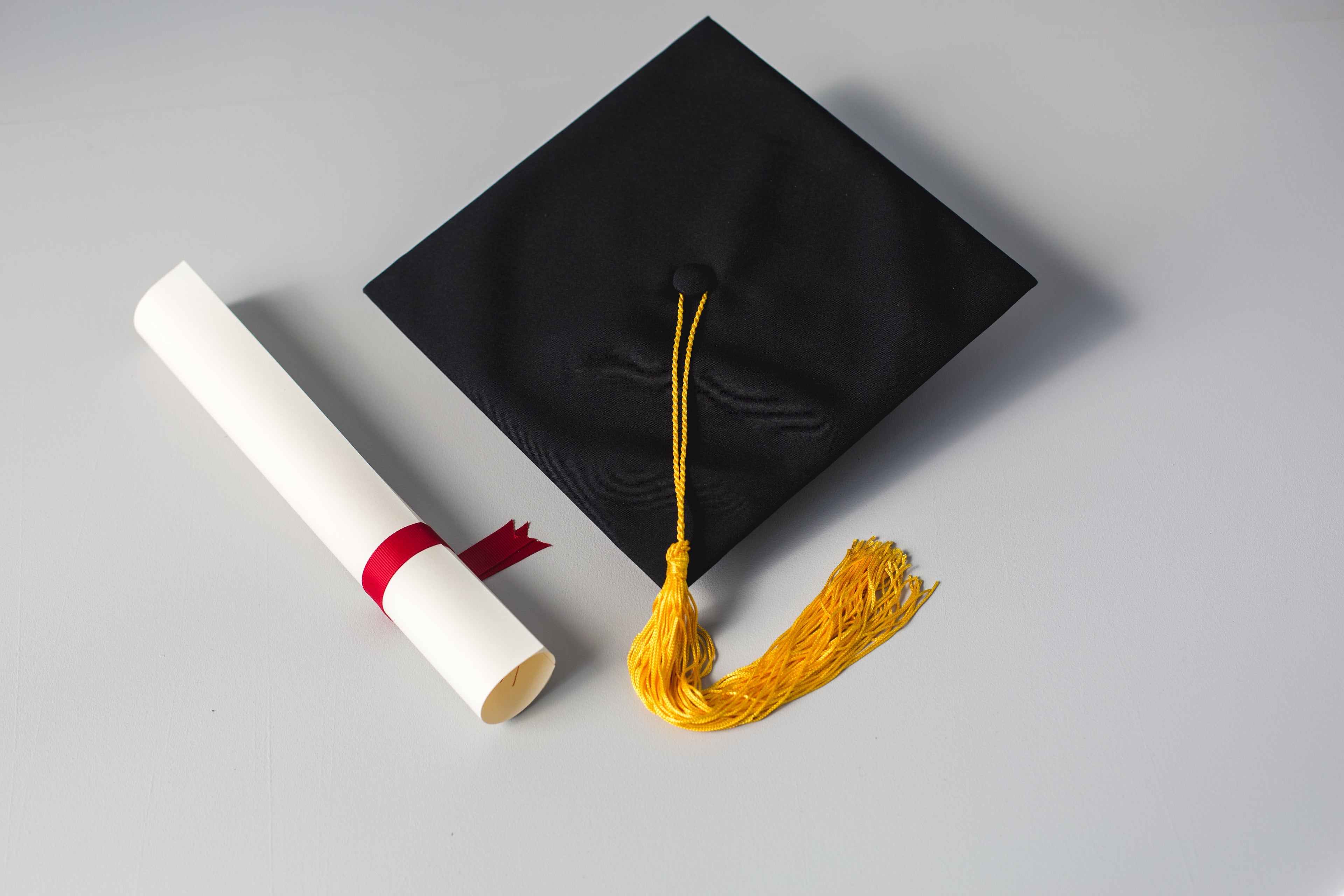 Graduation cap and diploma scroll representing the celebration of academic achievements