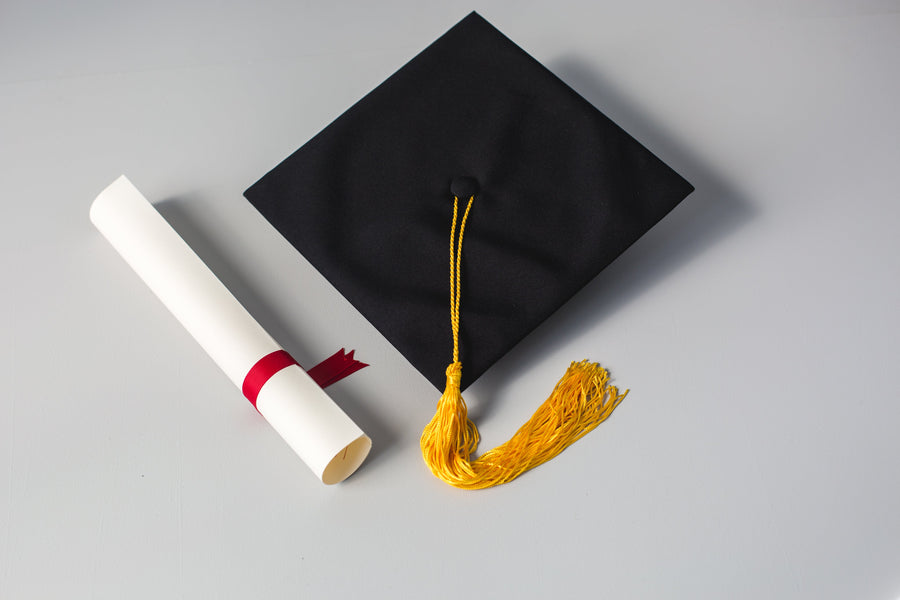 Graduation cap and diploma scroll representing the celebration of academic achievements