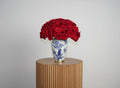 Stunning arrangement of 100 Red Roses in a beautiful blue vase for elegant floral decor
