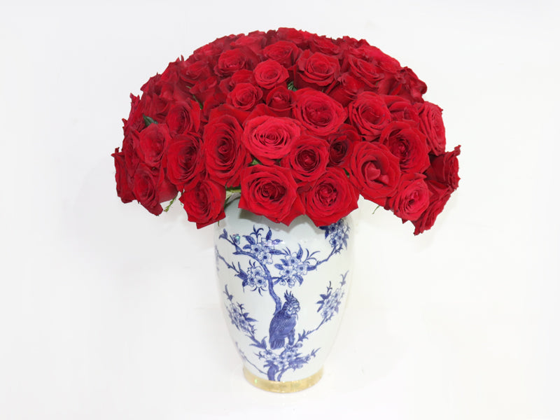 Stunning arrangement of 100 Red Roses in a beautiful blue vase for elegant floral decor