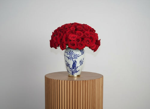 Stunning arrangement of 100 Red Roses in a beautiful blue vase for elegant floral decor