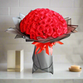 Elegant 100 Red Roses Bouquet arranged beautifully in a stylish black and red wrap