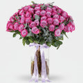 Bouquet of pink roses with a white ribbon on a light background