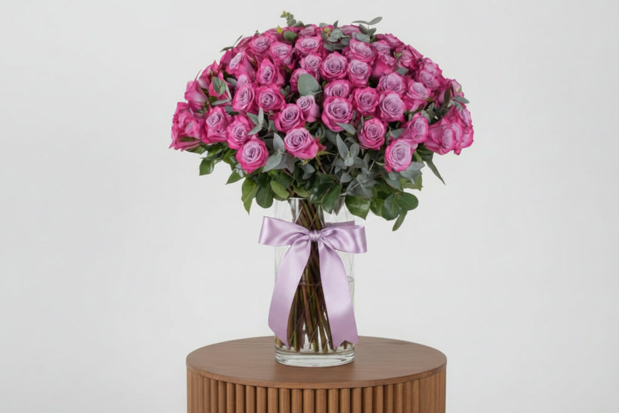 Bouquet of pink roses with a white ribbon on a light background