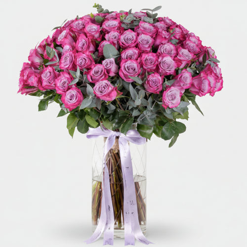 Bouquet of pink roses with a white ribbon on a light background