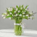 Bouquet of 40 white tulips in a clear vase with a white ribbon