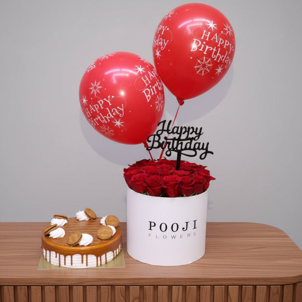 Birthday arrangement with red balloons, roses, and a cake