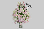 Bouquet of flowers with a 'Get Well Soon' sign on a gray background