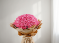 Bouquet of pink roses wrapped in brown paper on a white background