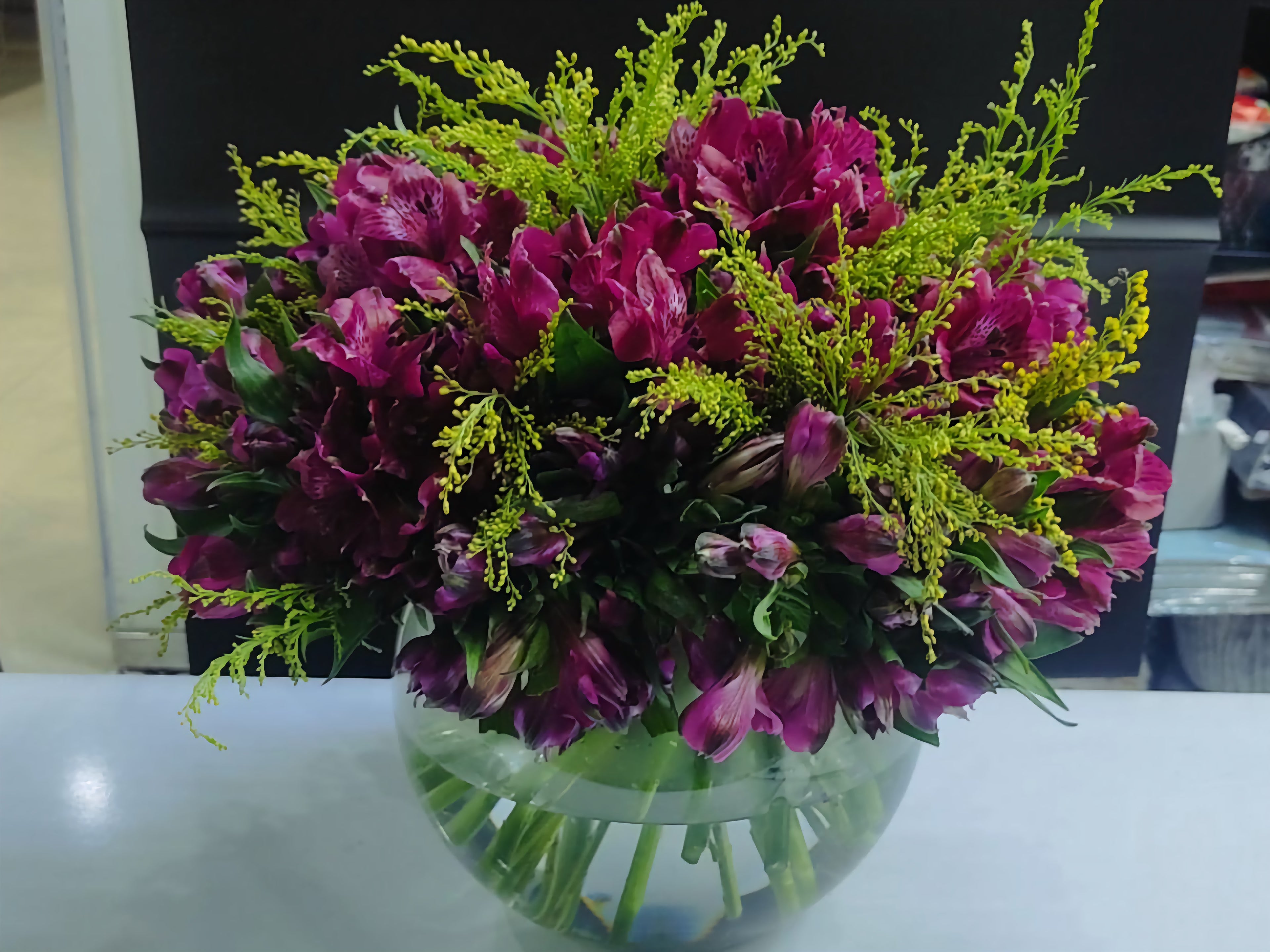 Bouquet of purple alstroemeria flowers in a clear vase