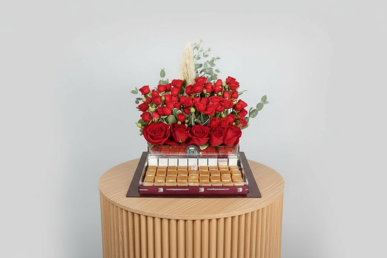 Bouquet of red roses with a tray of chocolates on a white background