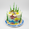 Cake decorated with shark characters and ocean-themed elements
