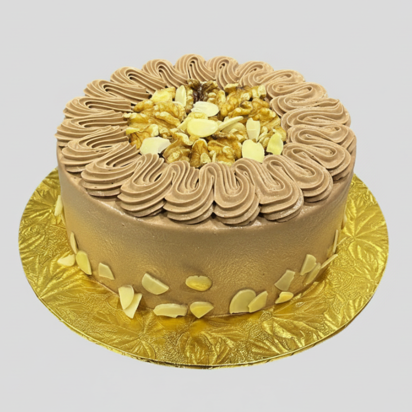 Chocolate cake with white flowers on a gold plate against a white background
