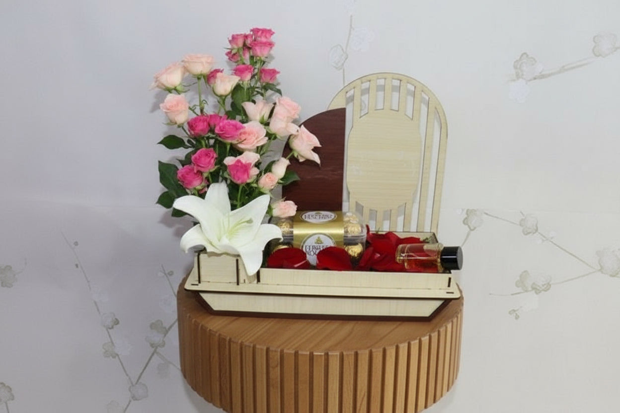 Gift basket with flowers, chocolates, and perfumes on a white background