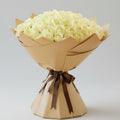 Grand bouquet of 100 white roses wrapped in elegant kraft paper with brown ribbon - luxury flower arrangement Kuwait