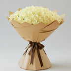 Grand bouquet of 100 white roses wrapped in elegant kraft paper with brown ribbon - luxury flower arrangement Kuwait