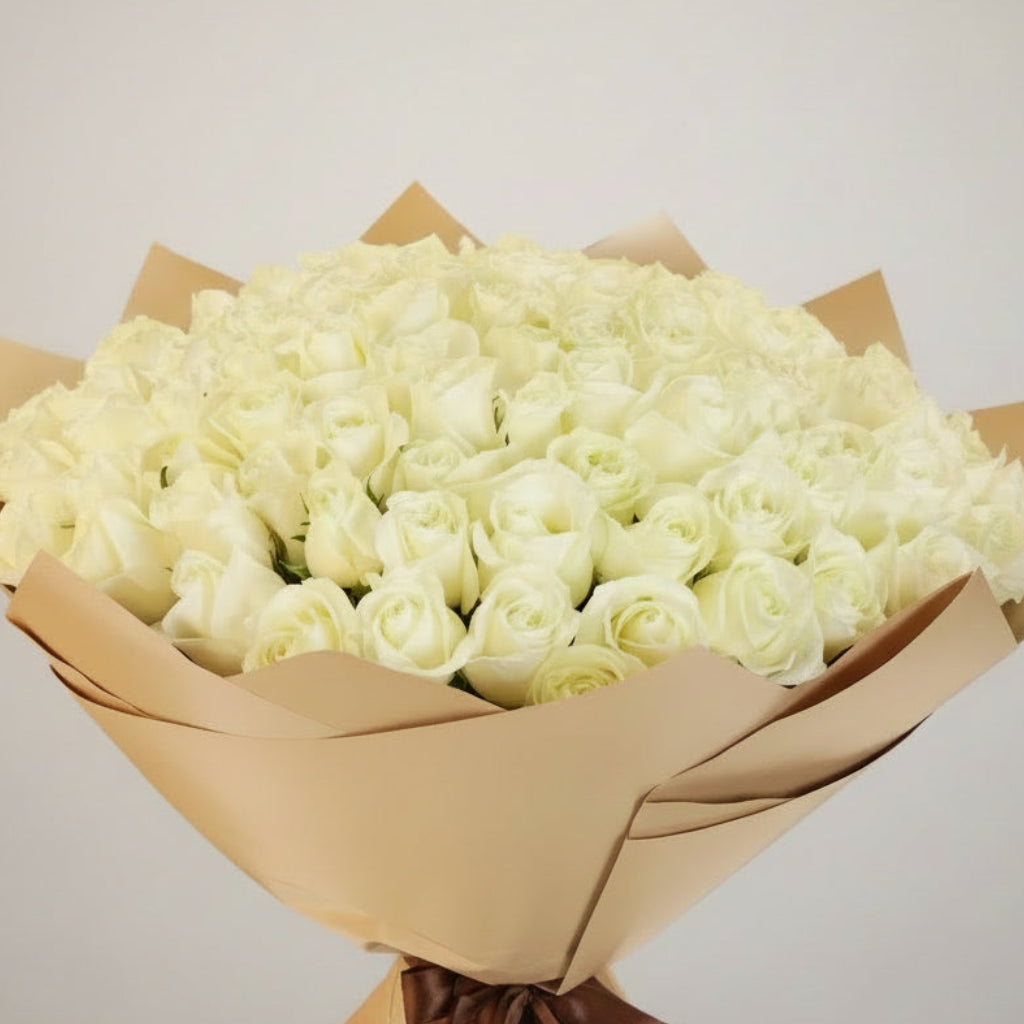 Bouquet of white roses wrapped in brown paper