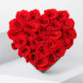 Heart-shaped arrangement of red roses with black ribbons