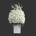 White floral arrangement in a rectangular white vase on a light gray background