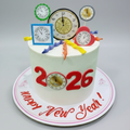 New Year's cake with clock designs and 'Happy New Year 2026' text on a pink background