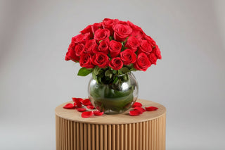 Bouquet of red roses in a clear vase on a white background
