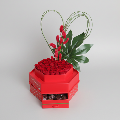Heart-shaped box of red roses with a heart-shaped arrangement on top