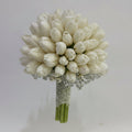 Bouquet of white tulips with decorative elements on a light gray background
