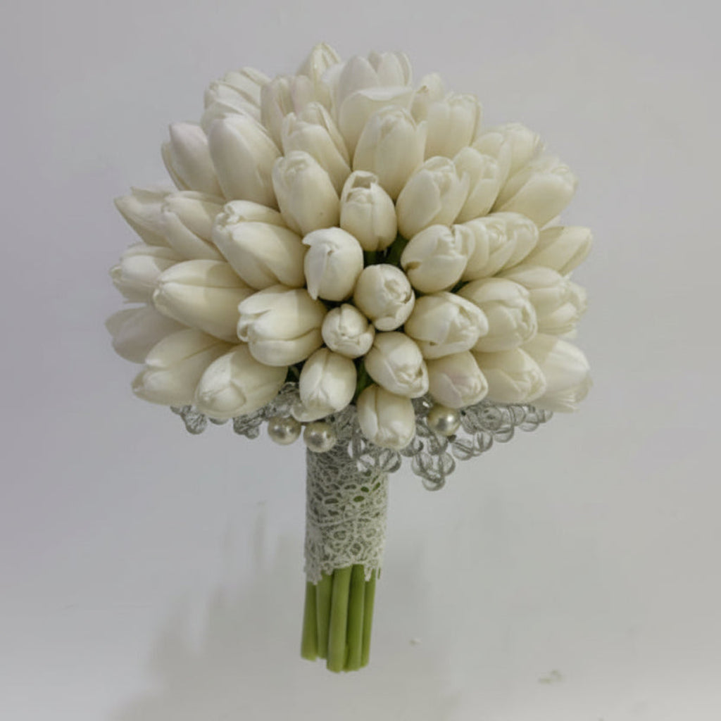 Bouquet of white tulips with decorative elements on a light gray background