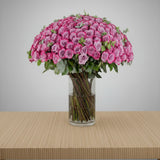 Purple Roses in Clear Vase