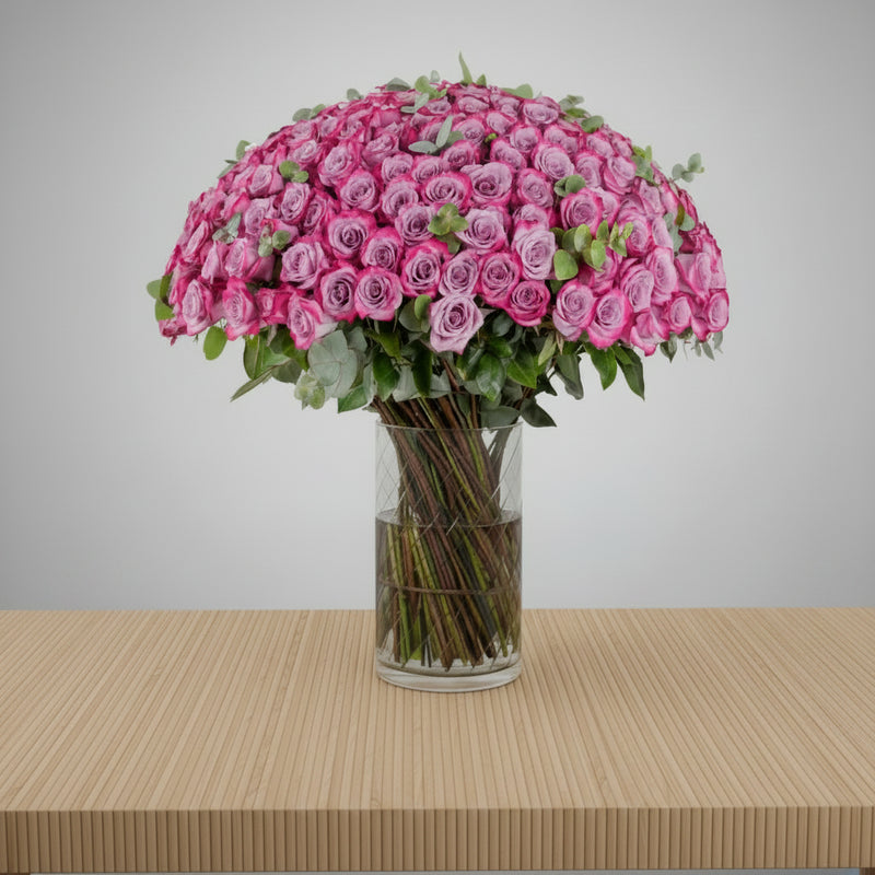 Purple Roses in Clear Vase