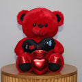Red teddy bear with a heart-shaped gift
