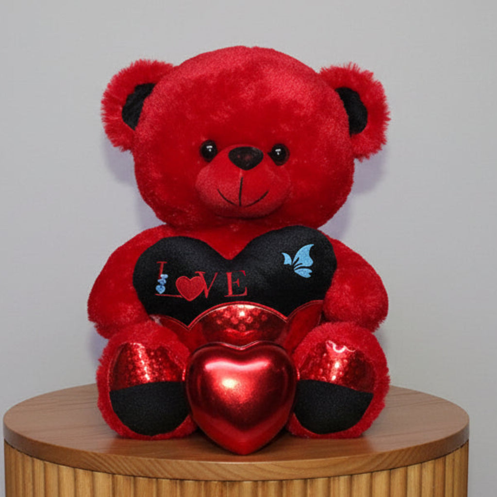 Red teddy bear with a heart-shaped gift