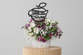Floral arrangement with a 'Thank You Teacher' decorative piece on a white background