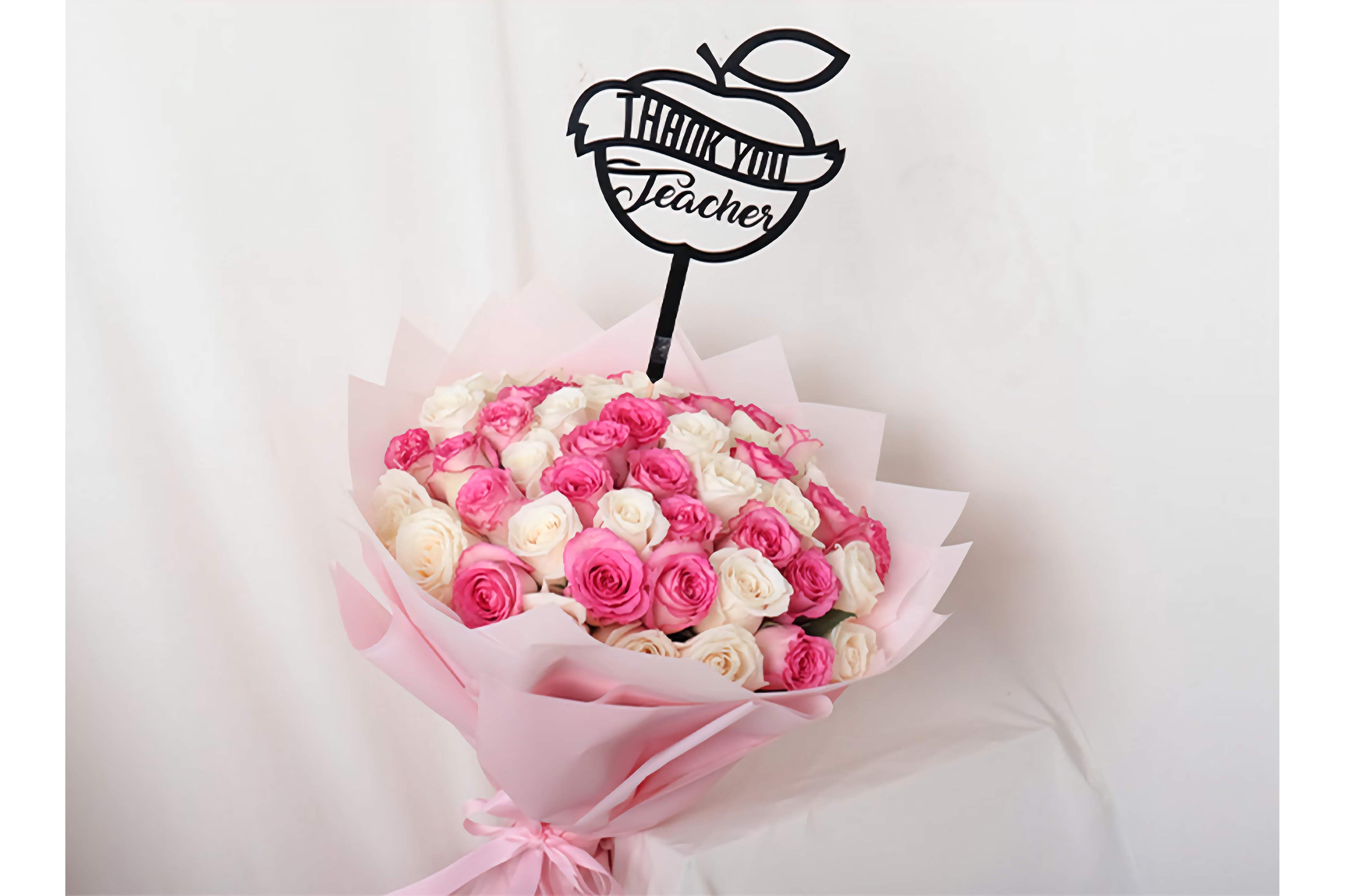 Bouquet of pink and white roses with a 'Thank You Teacher' apple-shaped card on a white background