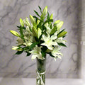 Elegant bouquet of Casablanca lilies in a glass vase, perfect for gifting or home decor