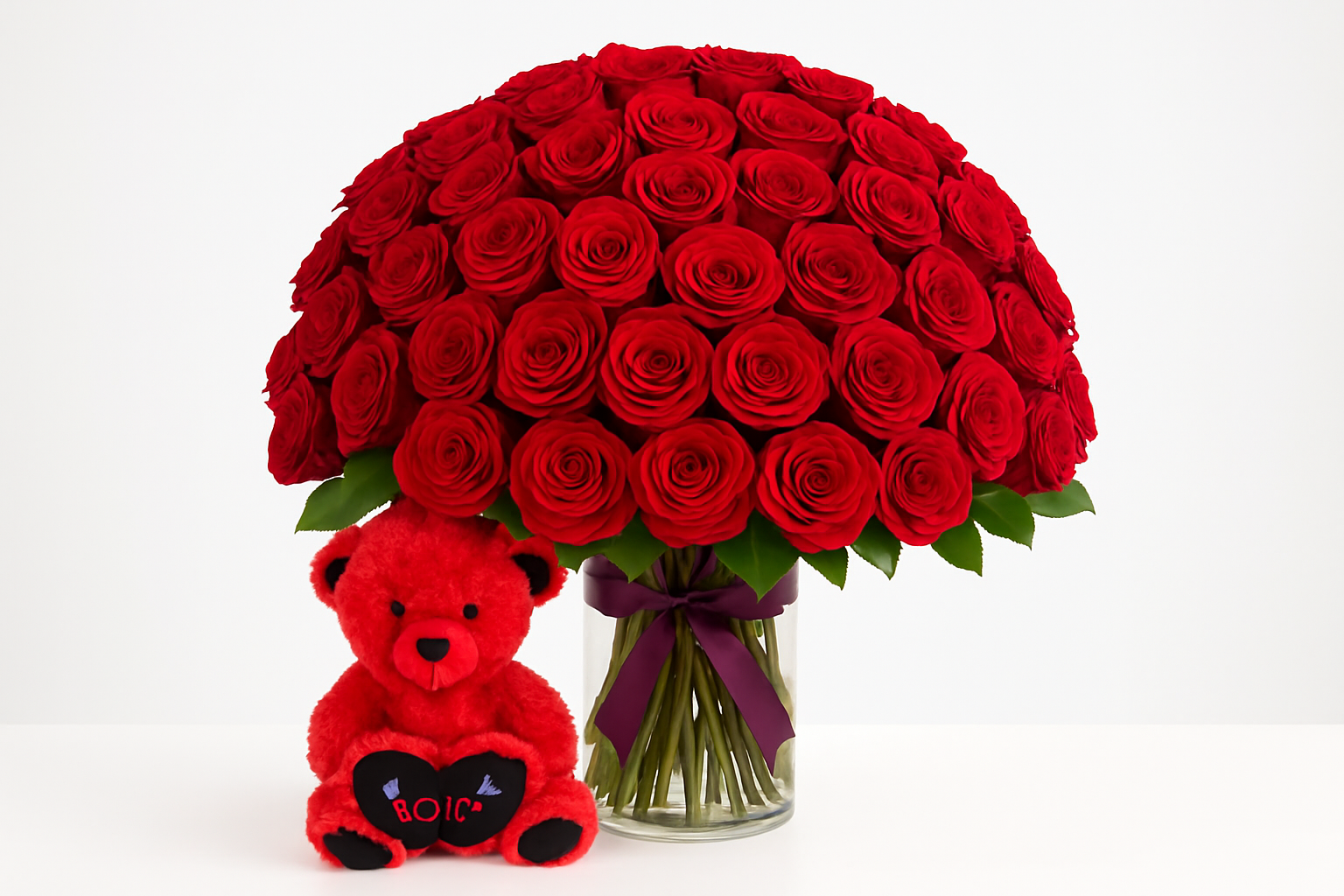 Centered 100 red roses arrangement with teddy bear