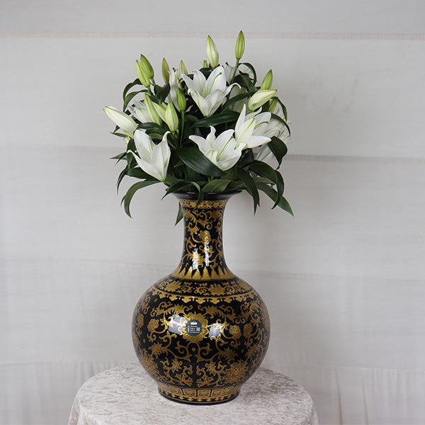 Elegant lilies in Ceramic Black & Gold Vase, showcasing a stunning floral arrangement for any Occassion