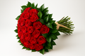 Bouquet of red roses with green leaves on a white background