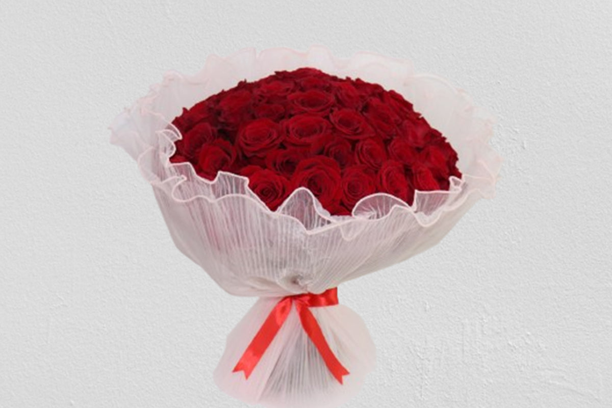 Elegant 50 Roses Bouquet with vibrant red flowers wrapped in delicate white netting and tied with a red ribbon