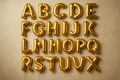 Gold helium balloons in the shape of letters A through Z in a square format