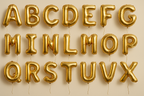 Gold helium balloons in the shape of letters A through Z