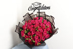 Bouquet of red roses with a 'Congratulations' graduation cap on a white background