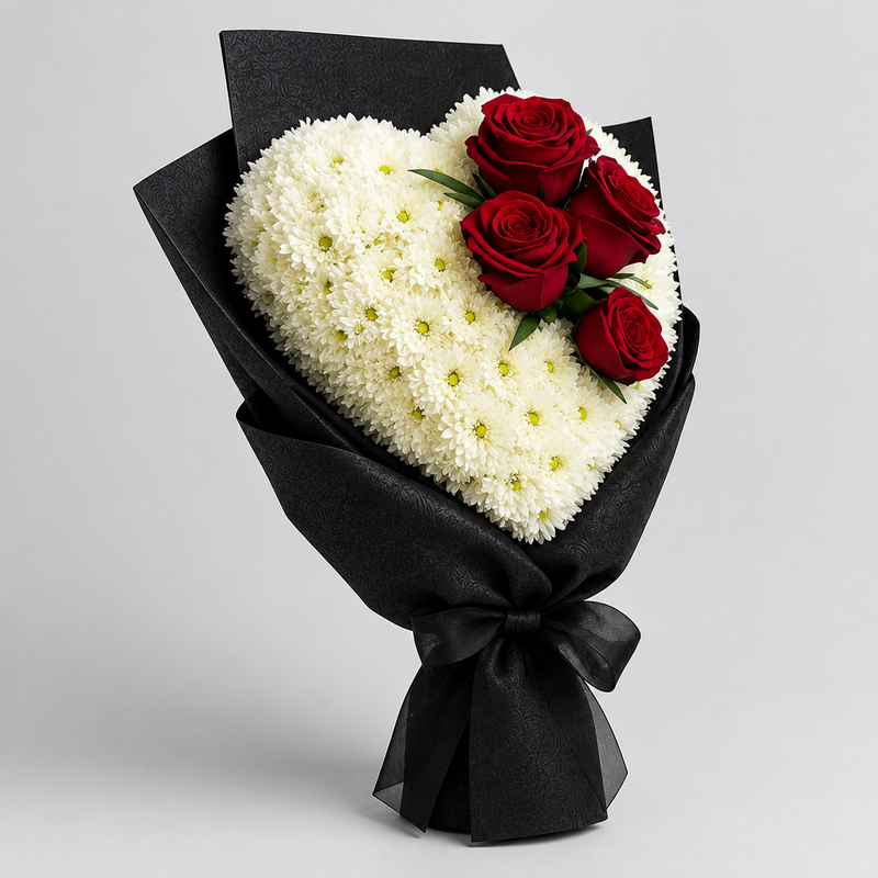 Eternal Love heart-shaped bouquet of white chrysanthemums and red roses shown from a 45-degree side angle