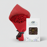 Close-up of red roses and a 16-piece chocolate box