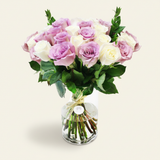 White and purple roses in a vase three-quarter view