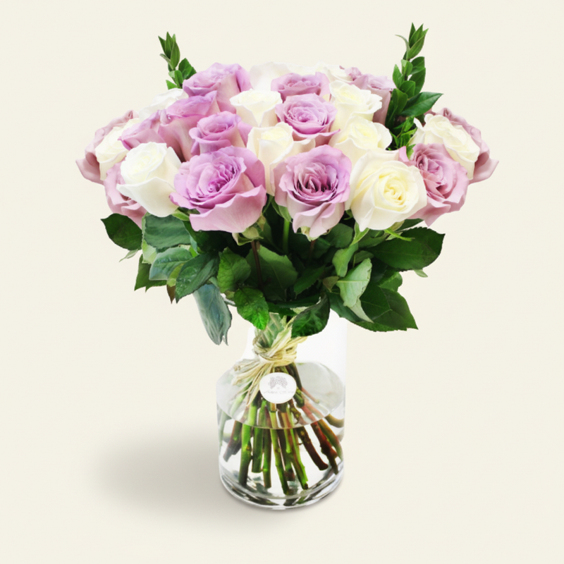 White and purple roses in a vase three-quarter view