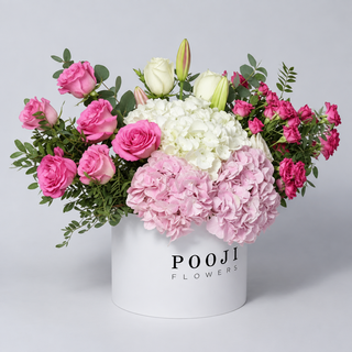 Pink Romance Luxury Flower Box shown from a 45-degree side angle with the Pooji Flowers logo and box depth visible