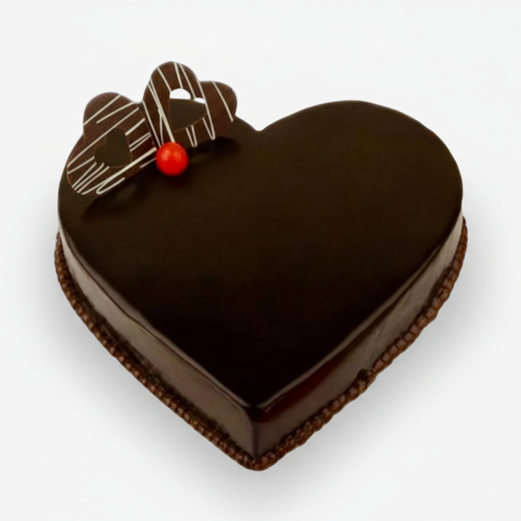 Heart-shaped chocolate cake with a decorative topper on a white background